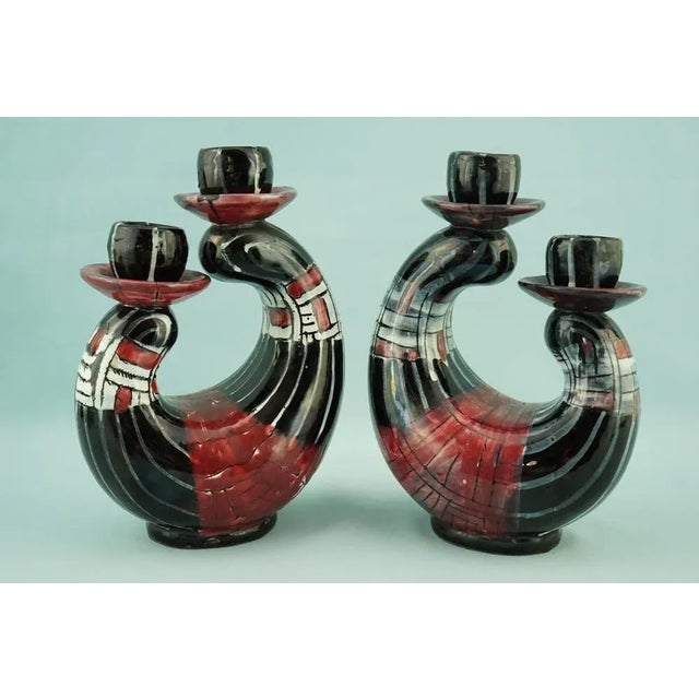 Item : A delightful pair of large, two-light candlesticks in vitrified majolica, entirely hand-molded and decorated with a...