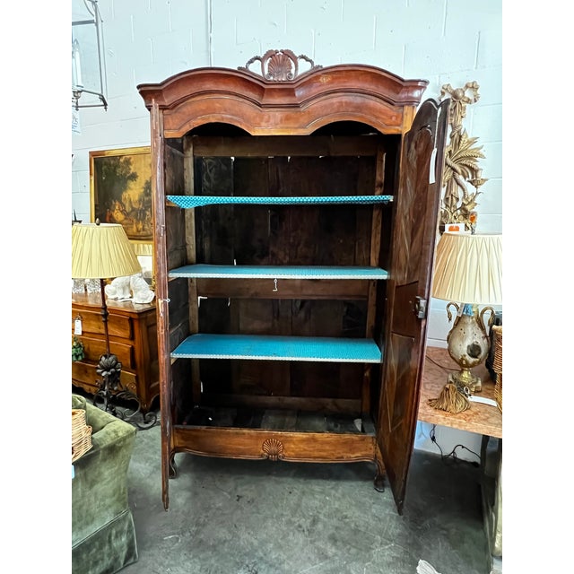 A stately and masterfully crafted French Provincial armoire, this piece dates to the late 18th or early 19th century....