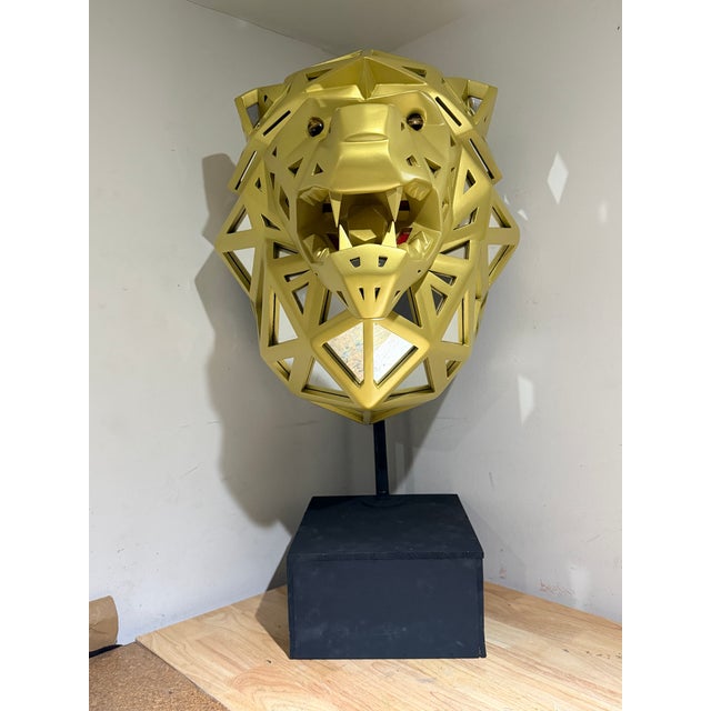 Handcrafted geometric lion sculpture made from oak wood and individual mirror cut for each frame. The lion features a...