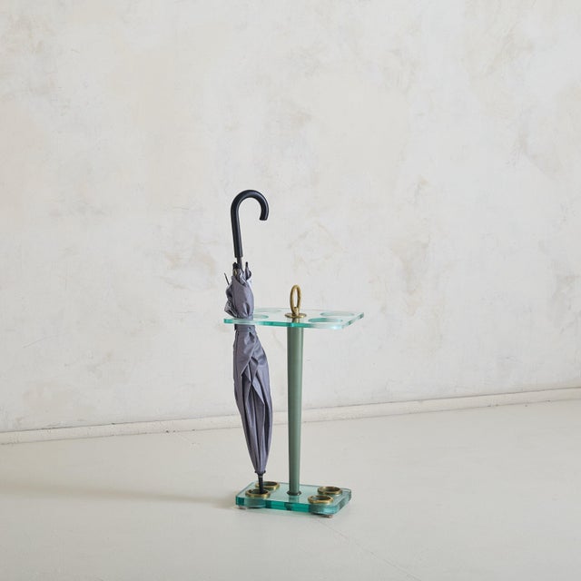 A 1950s Italian umbrella stand designed by Fontana Arte. Composed of thick, pale green tinted glass and a lacquered wood...