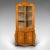 This is an antique showcase corner cabinet. A Dutch, satinwood bow-front display case, dating to the late Victorian...
