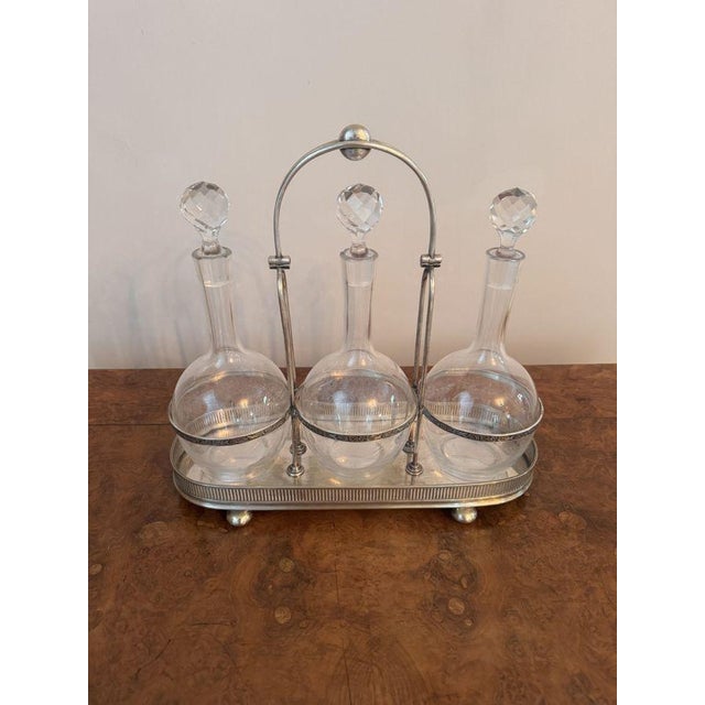 Quality antique Edwardian glass decanters and silver plated stand, having a quality antique Edwardian silver plated stand...