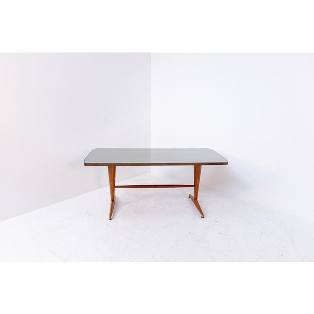 Beautiful Italian wooden table from 1950. The entire structure of the table was made of fine wood, embedded in the top, a...
