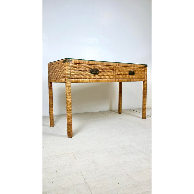 Vintage woven caning wrapped rattan campaign style console table. Woven caning with brass campaign hardware. Two drawers...