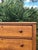 Charming antique pine chest of drawers featuring four spacious drawers, original round wooden knobs, and a beautifully...