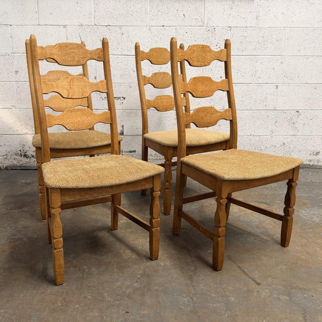 A set of four 1960s Razorblade dining chairs designed by Henning Kjærnulf for EG Kvalitetsmøbel, built in solid oak with...