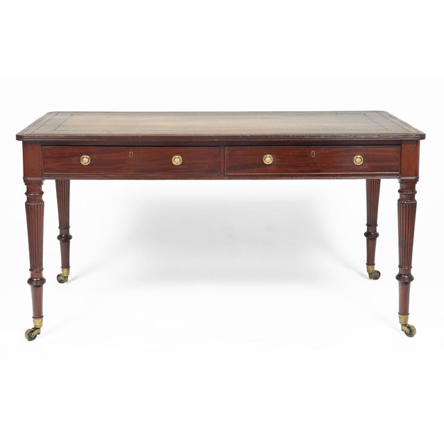 Regency period mahogany writing table with olive green gilt tooled leather surface, reeded top edge, two drawers to the...