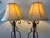 Make a dramatic statement with this striking matched pair of vintage Spanish Revival wrought iron floor lamps, featuring...