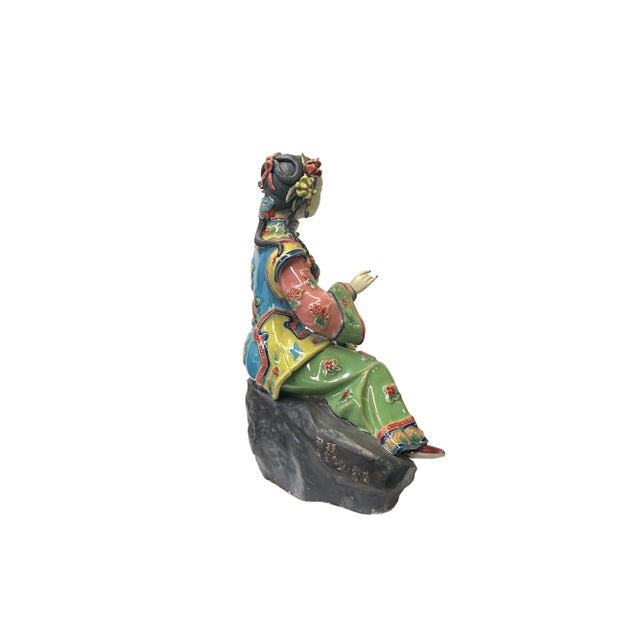 This Chinese Qing style dressing lady figurine is a beautiful and delicate piece of art. It is made of ceramic pottery and...