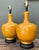 This vibrant pair of table lamps features a classic bottle silhouette, finished in a high-gloss mustard yellow glaze that...