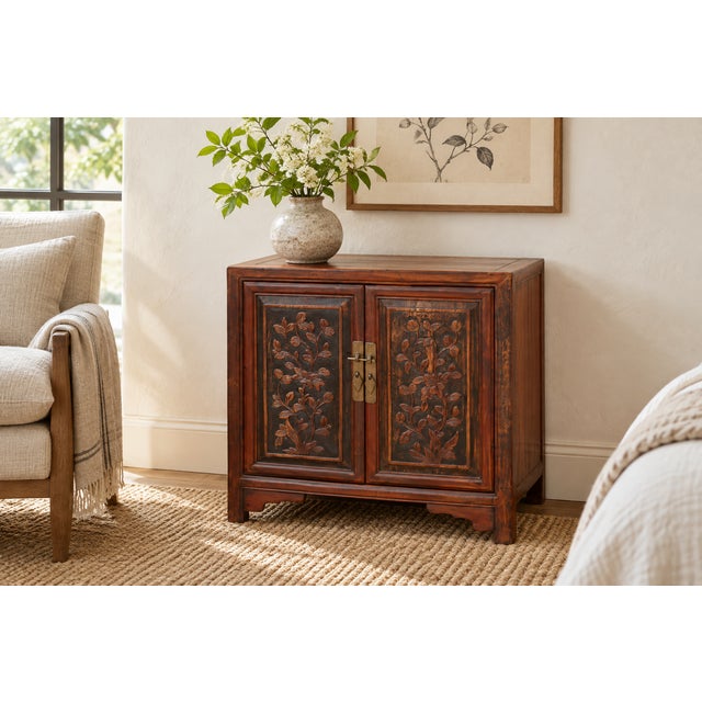 The first thing you notice is the carving. Flowering branches rise across both door panels in relief, each leaf and...