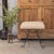 Iron stool with beautiful curved and looped base with matte black painted finish. Rectangular cushioned seat upholstered...