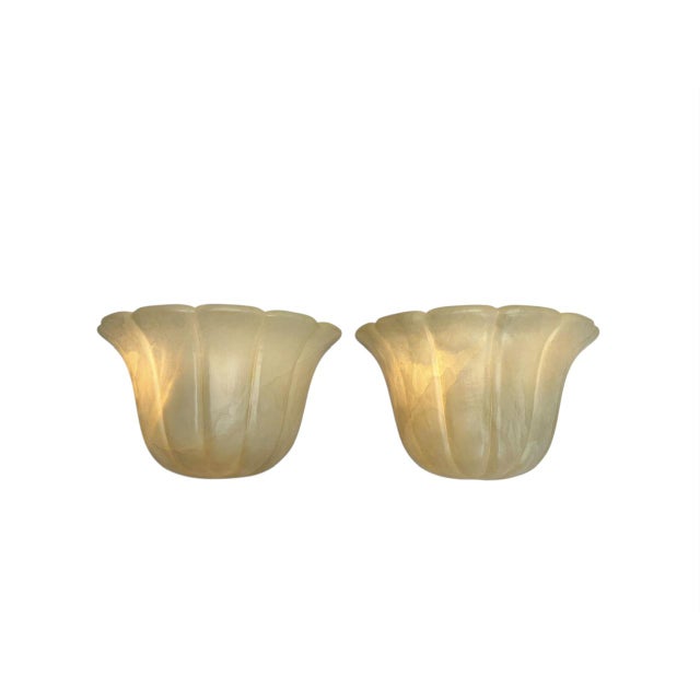 This elegant pair of Art Deco-style wall sconces in the shape of a tulip, crafted from ribbed alabaster, originates from...