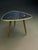 An original, triangular side table from the mid-century modern era. It features a very interesting design with a...