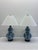 A sophisticated pair of Ralph Lauren Home double-gourd table lamps featuring classic blue and white porcelain bodies...