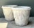 Adorned with classical architectural motifs, this pair of vintage cast cement planters features heavy relief-molded fruit...