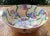 This sweet hand decorated bowl is covered entirely in a floral chintz pattern. there are swirls of six petalled flowers in...