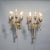 A matching pair of Arts and Crafts candelabra wall sconces offer cast & silvered metal frames with scroll form arms...