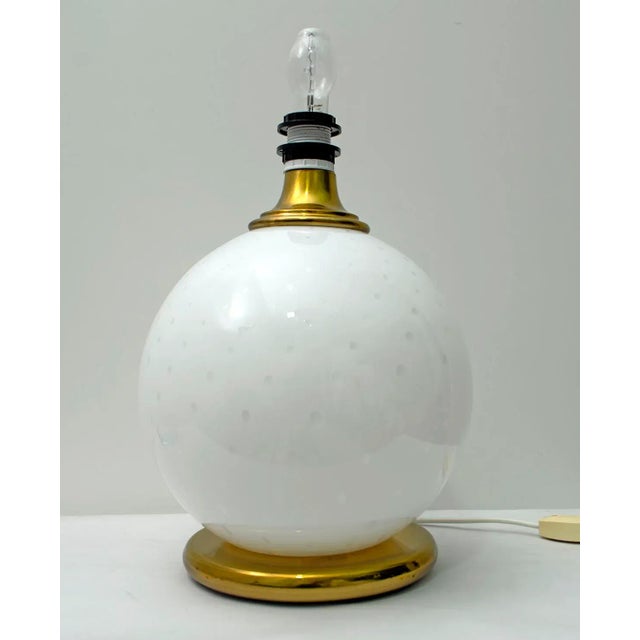 This lamp was created by Murano masters, with the technique of blown glass with air bubbles, the two supports are made of...