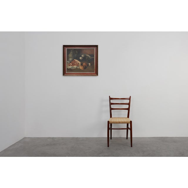 This evocative Flemish still life by J. De Bruyne, dated 1937, presents a beautifully balanced composition of rustic...