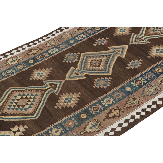 This vintage 5x13 Persian Kilim is believed to be a tribal rug of the 1950s. Handwoven in wool, its design enjoys...