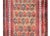 A wonderful vintage Afghani Baluch prayer rug with an all-over paisley pattern woven in crimson and brown wool set against...