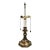 Mid-century brass candlestick table lamp in Vintage bronze finish, with dual bulbs, and brass bell pull strings. Manner of...