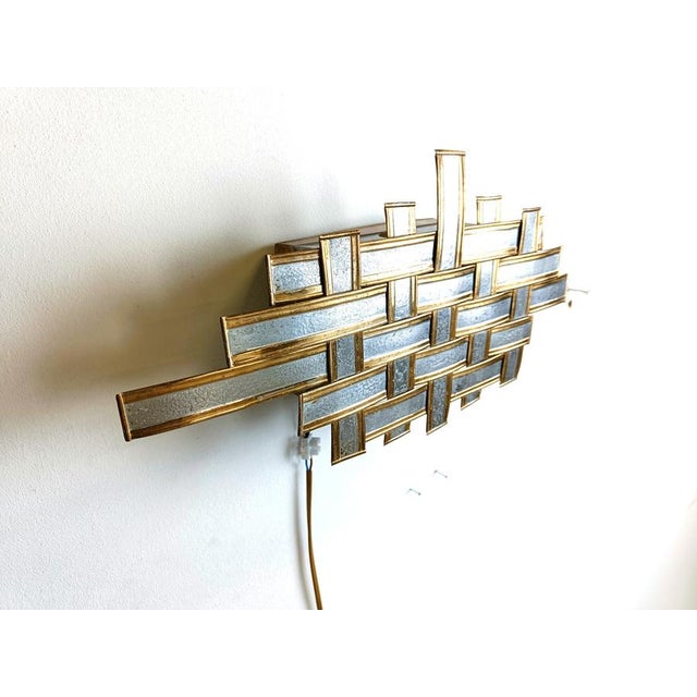Vintage brutalist design metal wall lamp. The lamp was made with metal strips woven into each other. Tested and ready to...