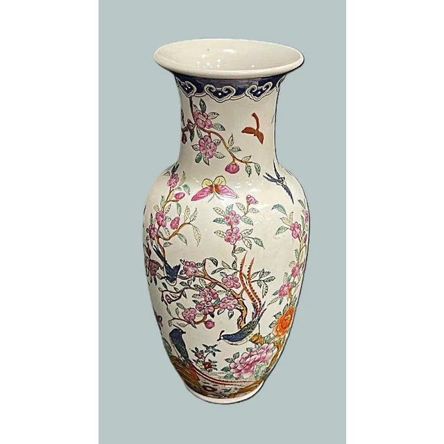 A beautifully hand painted Chinese vase featuring birds, butterflies, flowers and trees. A very traditional piece of...