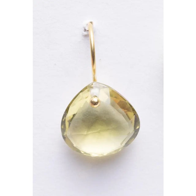 A pair of heart-shaped faceted lemon quartz drop earrings with an 18K gold wire for pierced ears. Simple and elegant. The...