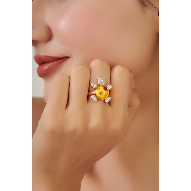 This bear cocktail ring featuring a 7.24 carat cabochon citrine, set in 18K yellow gold. The center stone measuring 12 mm,...