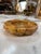 Heavy carved marble ashtray featuring warm caramel, cream, and brown tones with distinctive natural veining. Its...