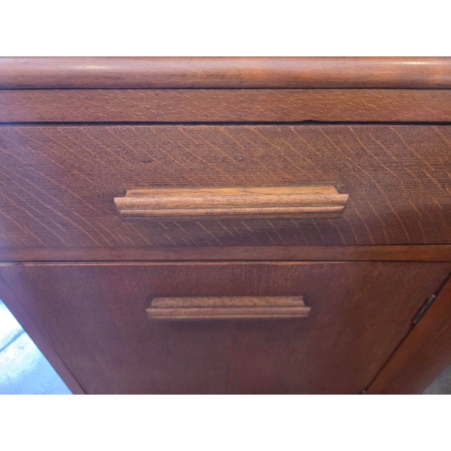 A nice Art Deco Oak Coat Rack. Six hooks , mirror , cabinet and a drawer. Nice unusual piece. Made by Heals of London.