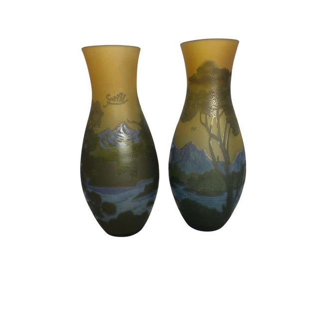 A beautiful pair of emile galle-style cameo-cut glass vases, 20th century. In “mountain lake” decor, signed at one side...