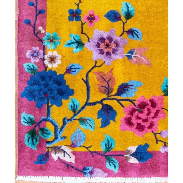 This rug follows the asymmetric composition that defines Chinese Art Deco rugs.The flowering branches are not mirrored...