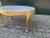 A refined 1940 French Louis XVI-style coffee table, crafted from gilded beech wood and finished with its original marble...