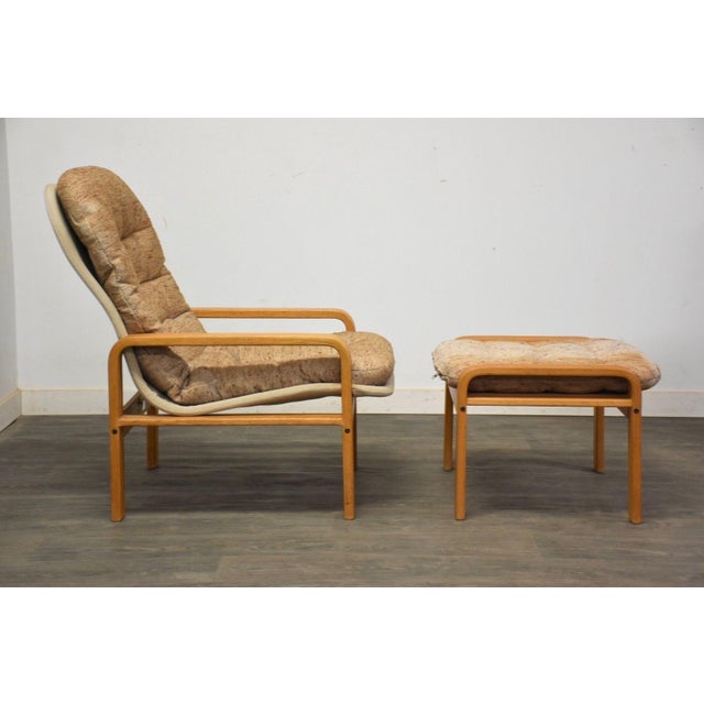 A mid century modern style oak bent plywood lounge chair and ottoman made by Brigger Furniture. Some discoloration seen in...