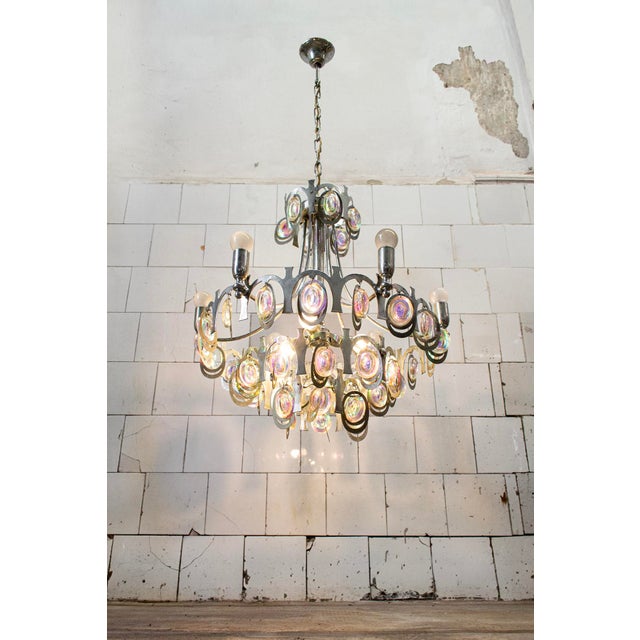 9-light chandelier with a chromed steel frame and glass crystals with rainbow-colored reflections. Designed by Gaetano...