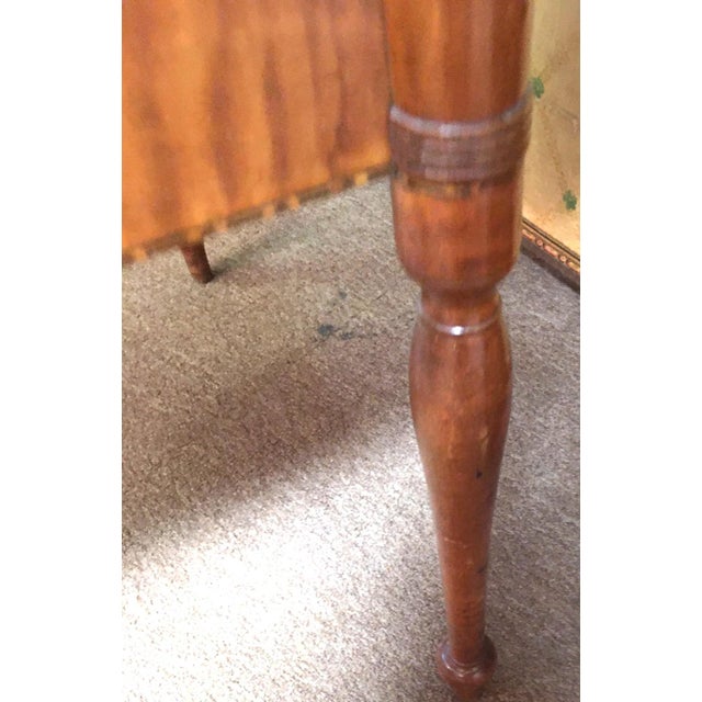 This handsome New England American Sheraton two-drawer stand features cookie corners terminating on graceful turned ringed...