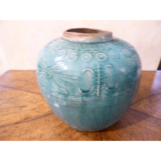 This turquoise crackle glazed ceramic was once used for storage of food.
