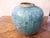 This turquoise crackle glazed ceramic was once used for storage of food.