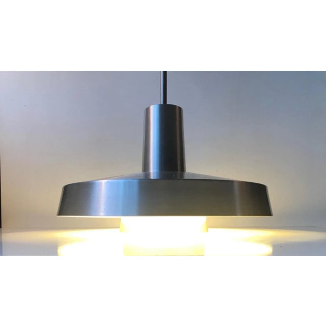 A rare brushed aluminium pendant light from Lyfa in Denmark. It is called Top 2 and was designed in 1972 by Eva & Niels...