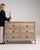 A substantial oak chest of drawers showcasing traditional French craftsmanship and functional design. The solid...