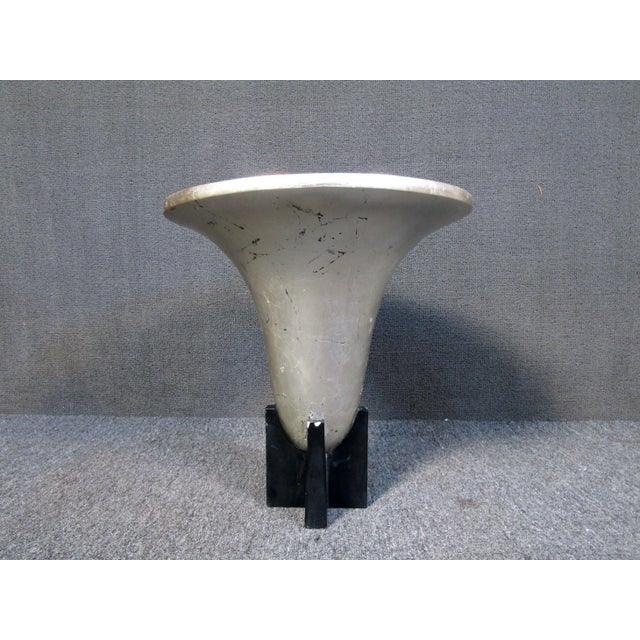 This art deco urn features an elegant bell shaped appearance and silver leaf style finish. The perfect accent for any mid...