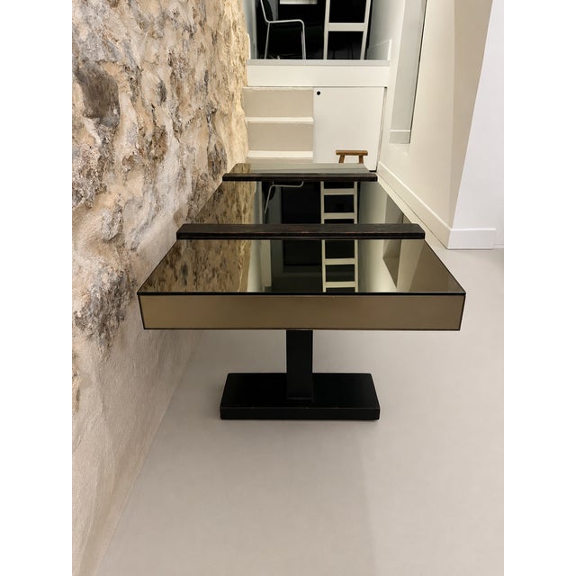 French decorative modernist table, smoked mirror top and geometric base with dark wood plinths.