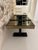 French decorative modernist table, smoked mirror top and geometric base with dark wood plinths.