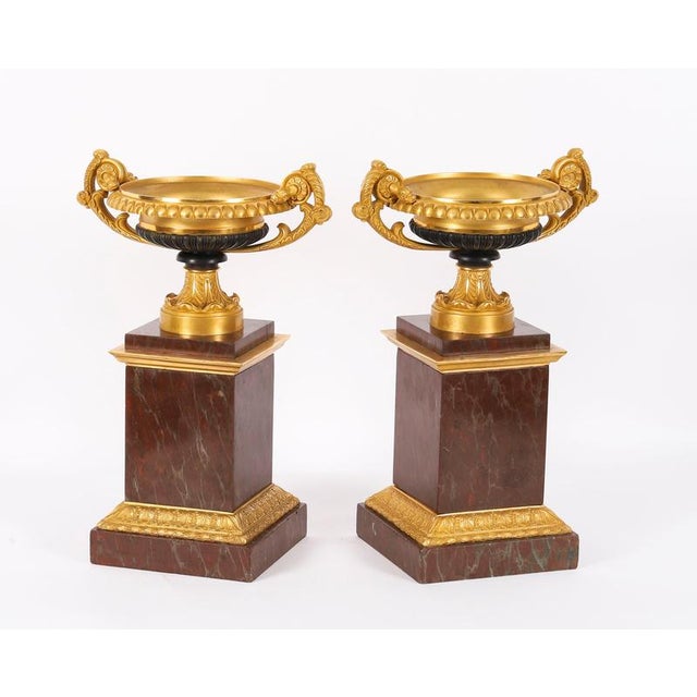 A fine antique fine pair of French Grand Tour patinated ormolu, bronze and marble tazzas, circa 1850 in date. This superb...