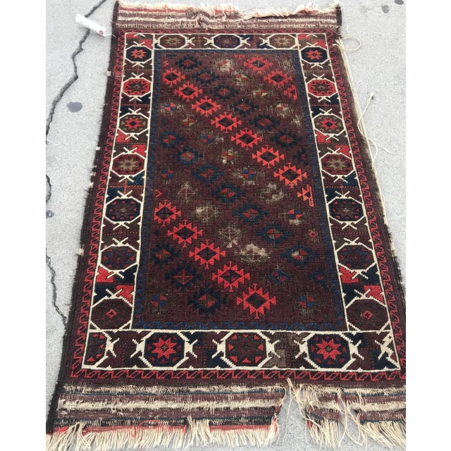 AN ANTIQUE VINTAGE DESIGN BALUCHSTAN TRIBAL RUG. It’s circa 1900s it is in Worn condition . The sides and he’s and end...