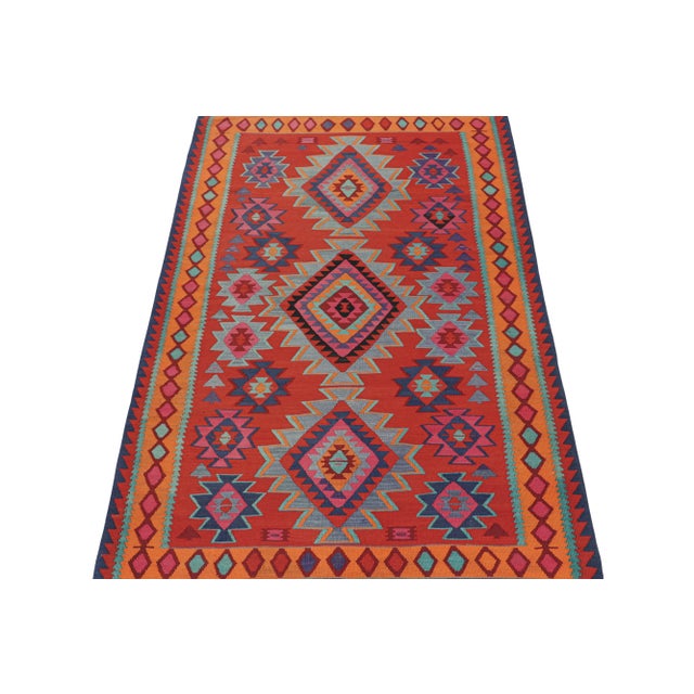 This vintage 6x9 Persian Kilim is handwoven in wool and originates circa 1950-1960. This Kilim is believed to hail from...