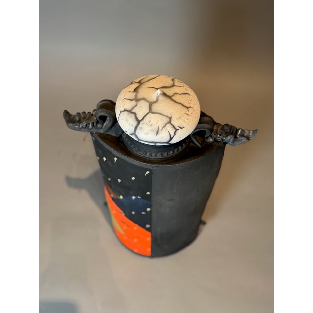 This stunning handcrafted ceramic jar is a masterful fusion of contemporary art and functional pottery. Featuring a bold...
